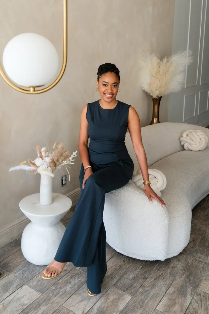 Jheanelle Bishop, founder of Joie Jae Events, seated in a bright studio