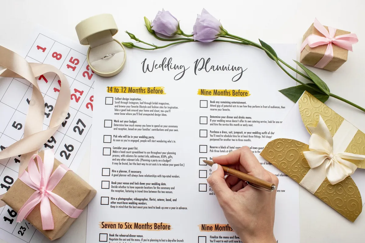 A hand ticking off a wedding planning checklist beside ribbons and a calendar