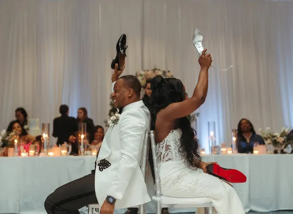 A bride and groom laughing at their reception table